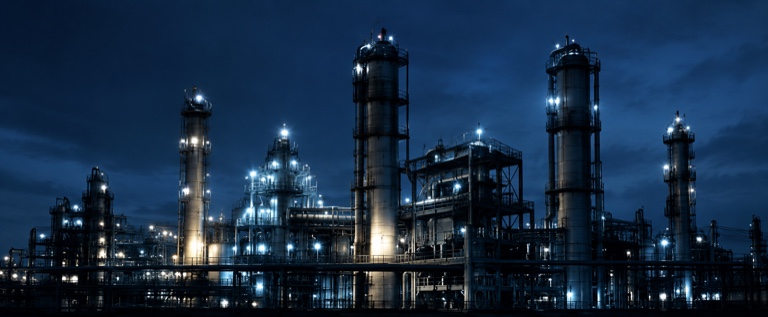 An illuminated industrial complex at night